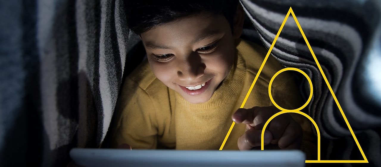 Photo of young boy looking at a tablet with an outline of the Powering lives graph