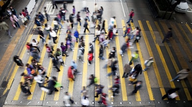 People cross a busy street in Hong Kong