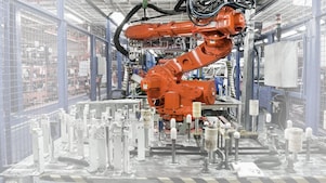 a red robotic arm in a factory