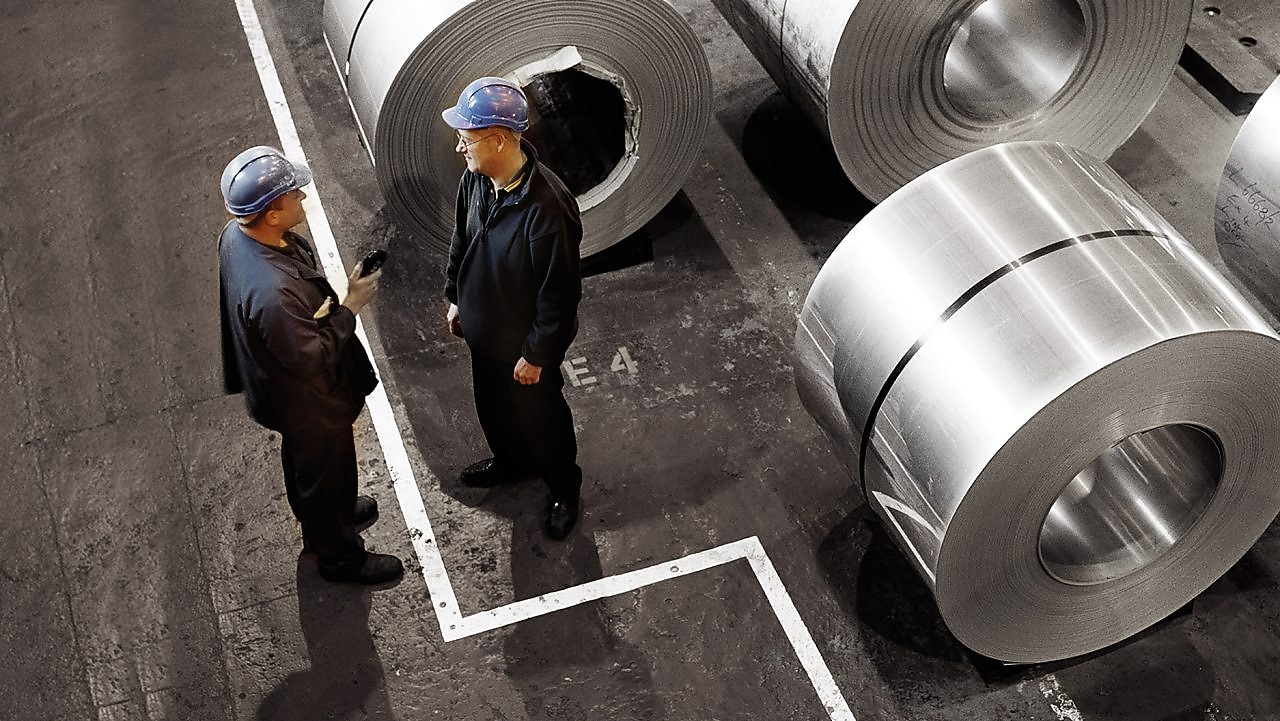 two workers in a metal factory