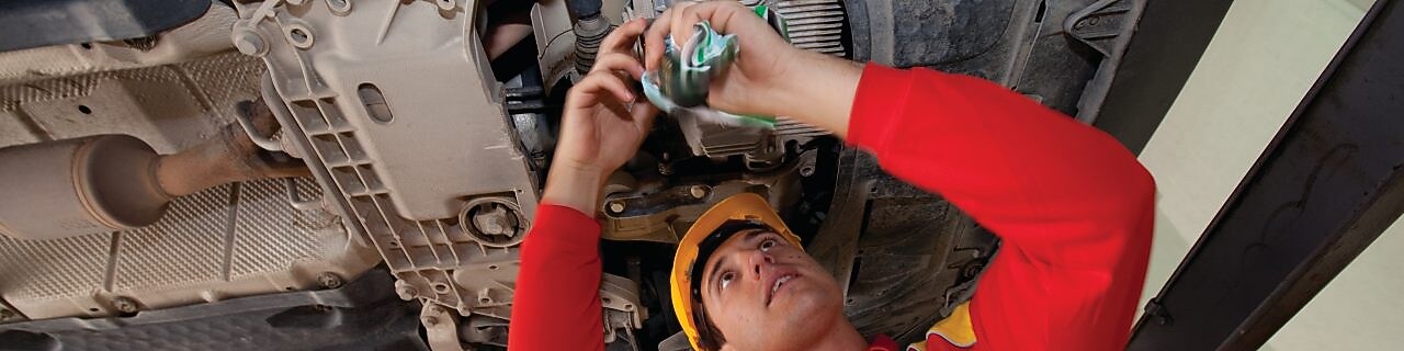 employee doing fitting of parts in car