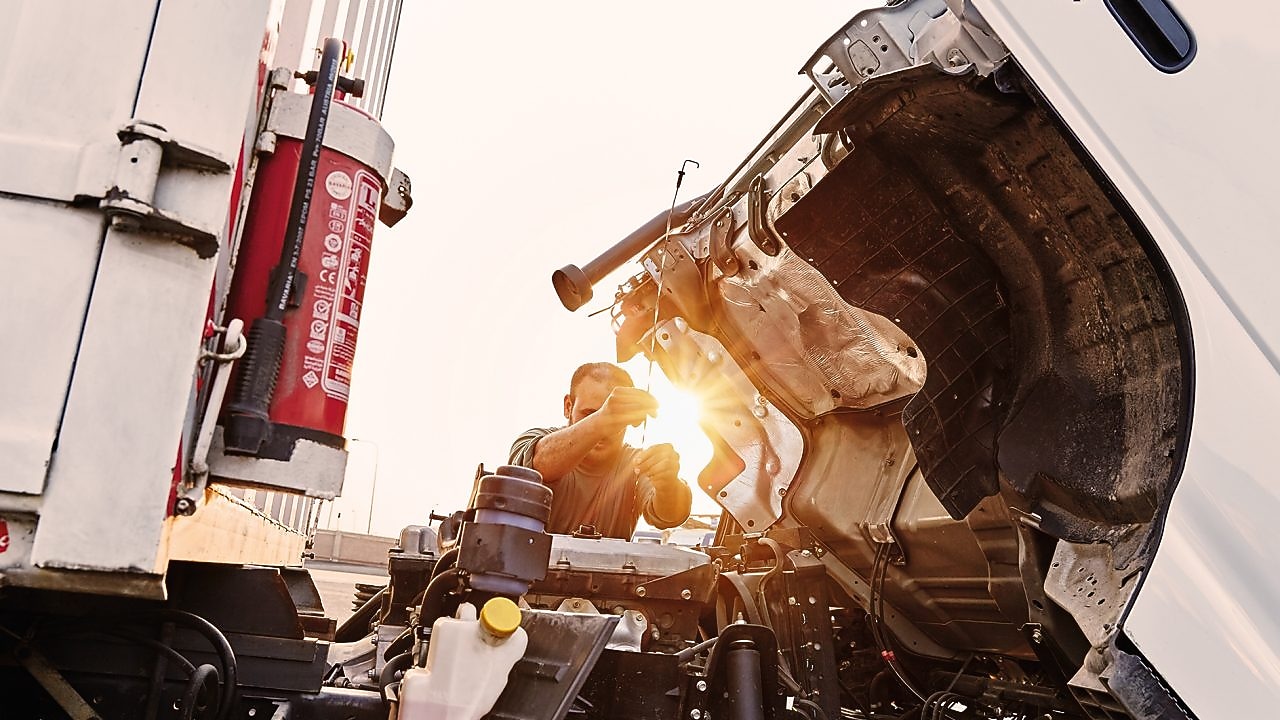 man-checking-truck-engine