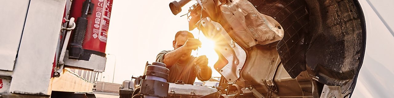 man-checking-truck-engine