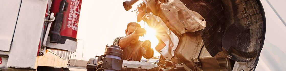 man-checking-truck-engine