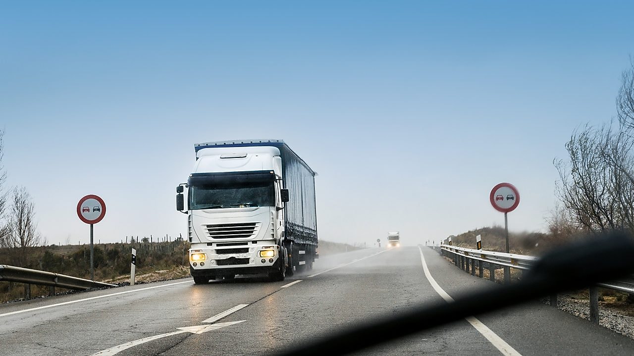 road with two heavy trucks coming