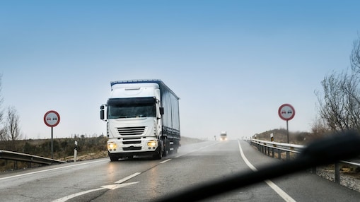 road with two heavy trucks coming