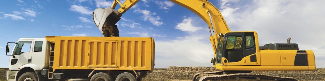 yellow excavator loading mud into a truck