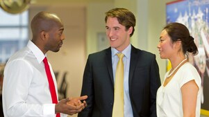 Three employees discussing work