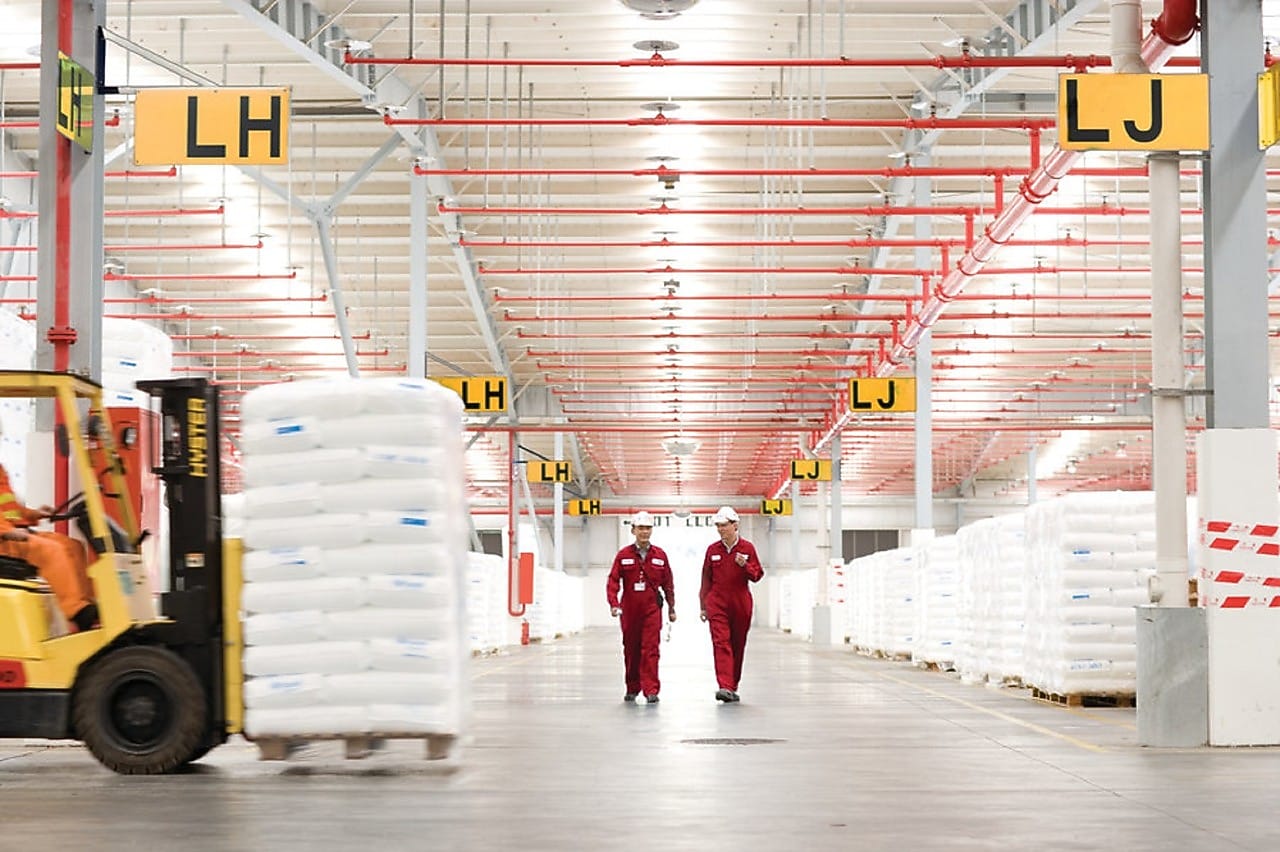 Two employees walking in a factory