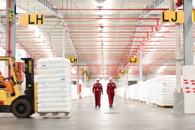 Two employees walking in a factory
