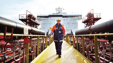 worker walking around a Shell vessel