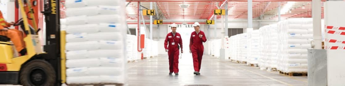 Two employees walking in a factory