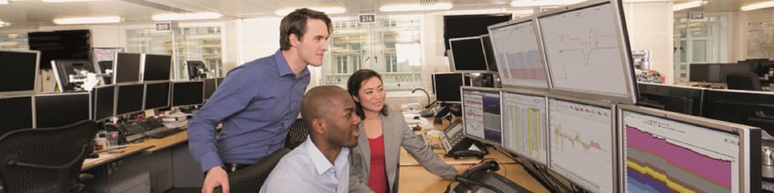 Staff on the Trading Floor examine data on multi computer screens