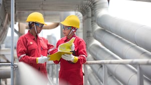 two workers discussing a project in a refinery in Malaysia