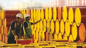 two employees transporting Shell barrels