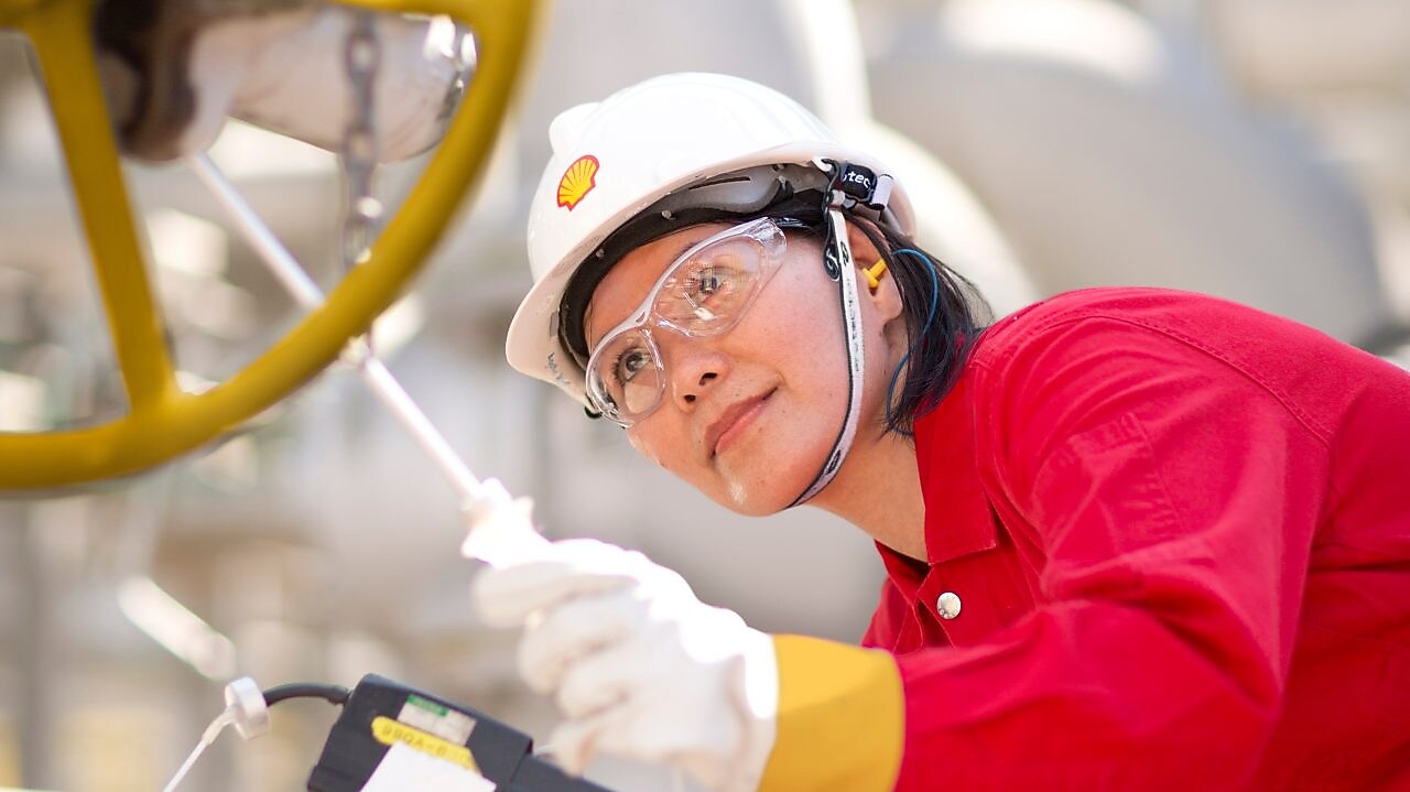 female employee inspecting equipment