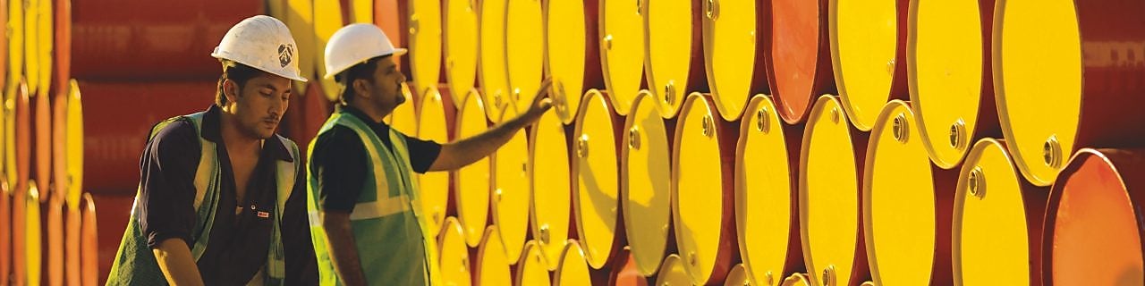 two employees transporting Shell barrels