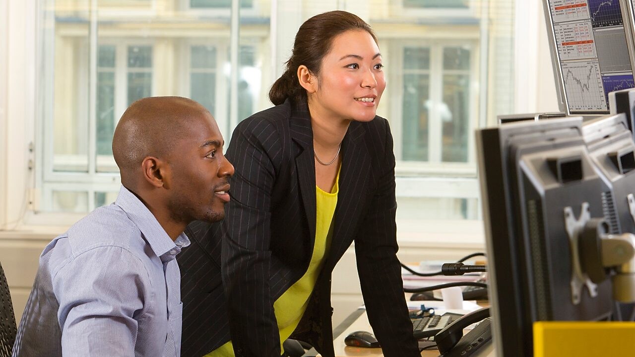 Employees looking at a computer screen