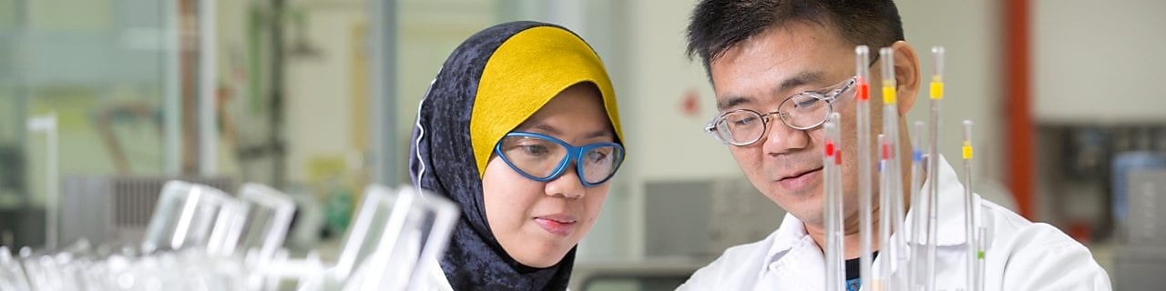 Two employees working in a production lab