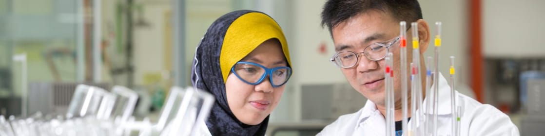 Two employees working in a production lab