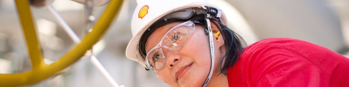 female employee inspecting equipment