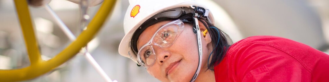 female employee inspecting equipment