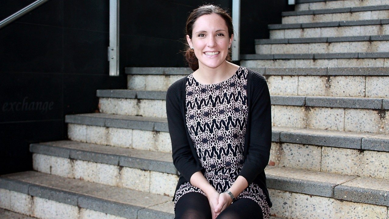 Siobhan Kelly smiles in front of a set of concrete stairs