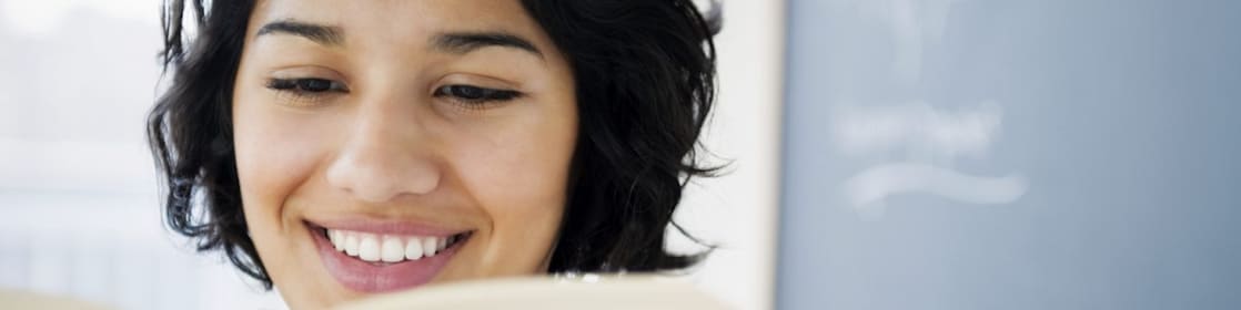 Hispanic woman reading book