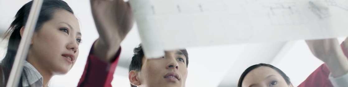 Graduates discussing design plans at work