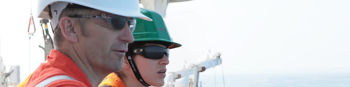 man and woman watching from ship