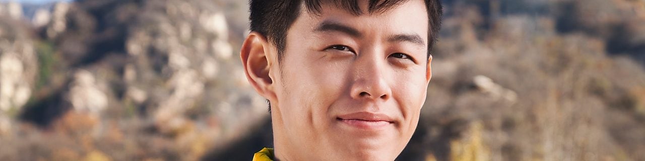 man with binoculars in rural landscape