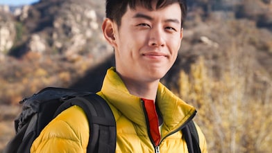 man with binoculars in rural landscape