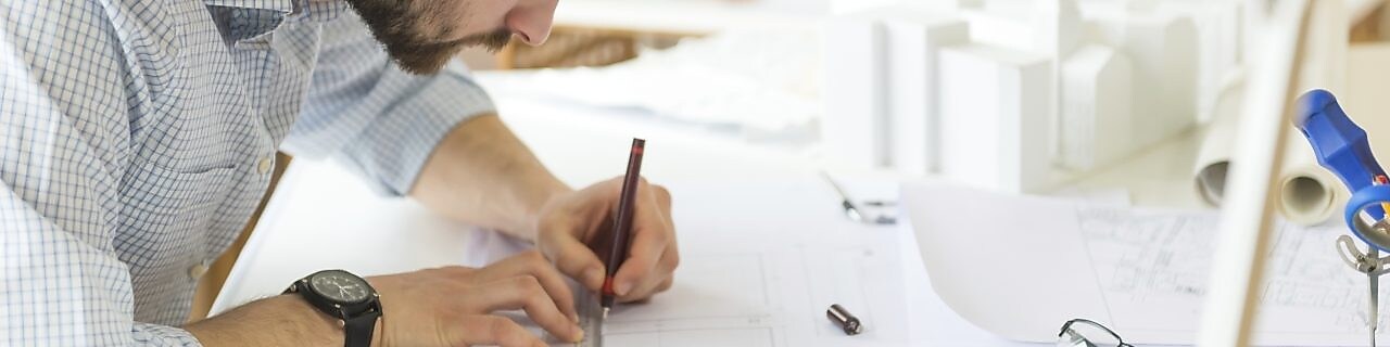 young architect drawing something on paper