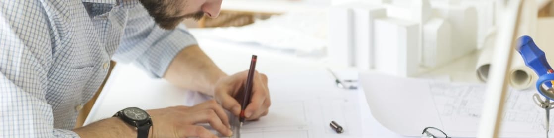 young architect drawing something on paper