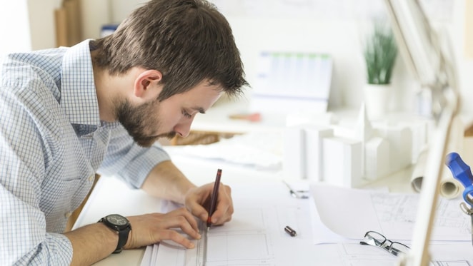 young architect drawing something on paper