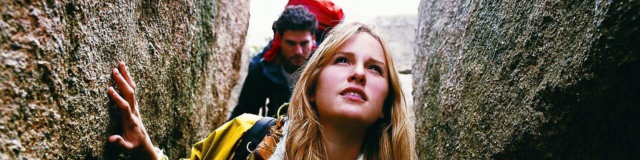 Two People Orienteering Between Rocks