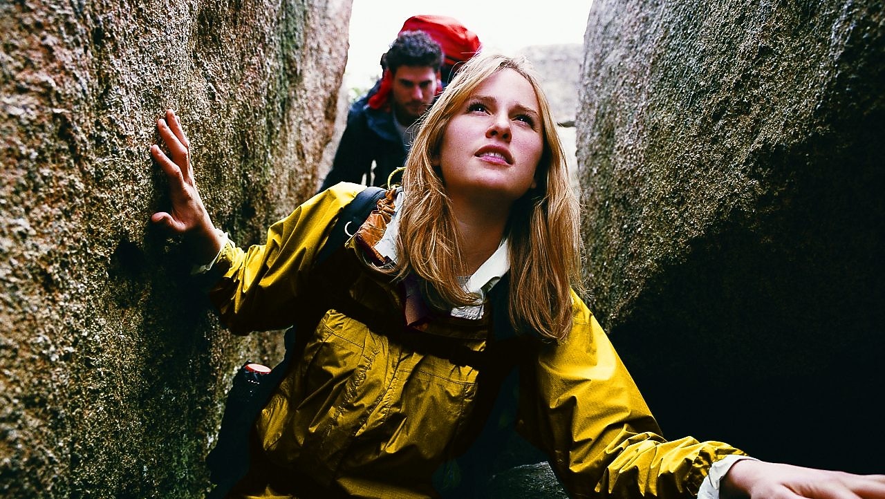Two People Orienteering Between Rocks