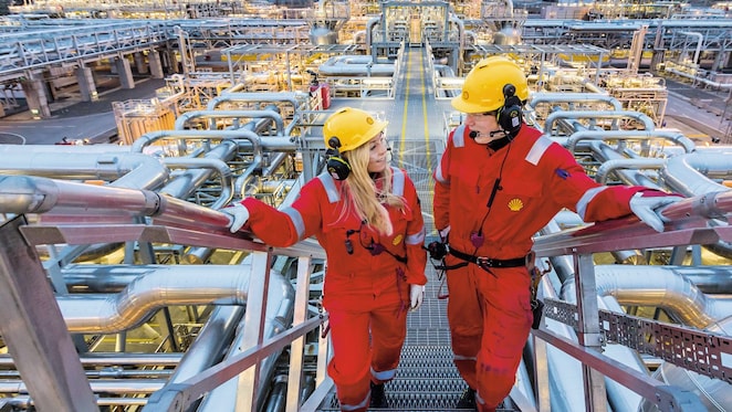 Two shell employees talking at work site