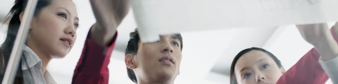 man showing bluprint to colleagues