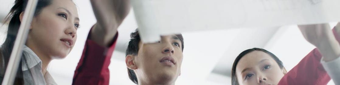 man showing bluprint to colleagues