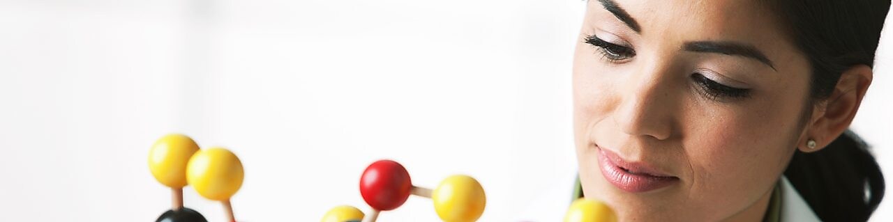 scientist looking at molecule model