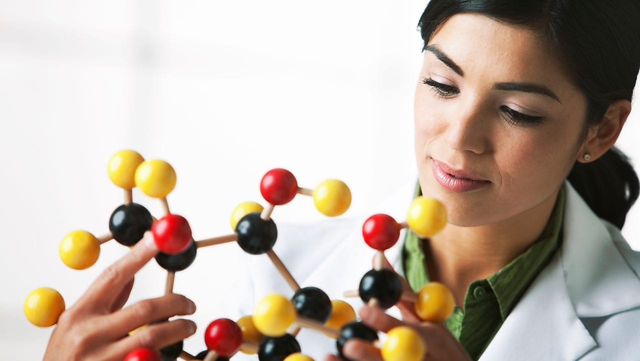 scientist looking at molecule model