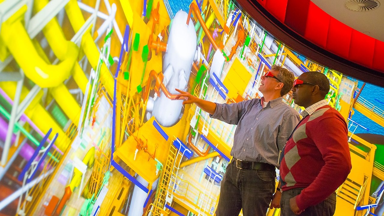 two man watching big screen with 3d glasses