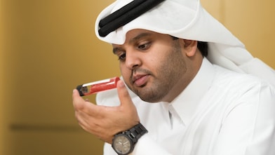 Mohammed Al Athba examines the contents of a capped test tube