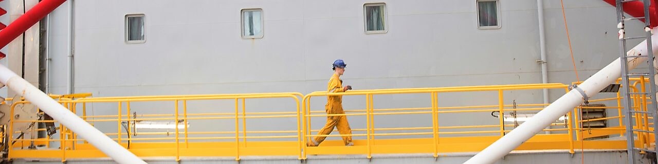 Engineer walking across a North sea offshore platform in Aberdeen