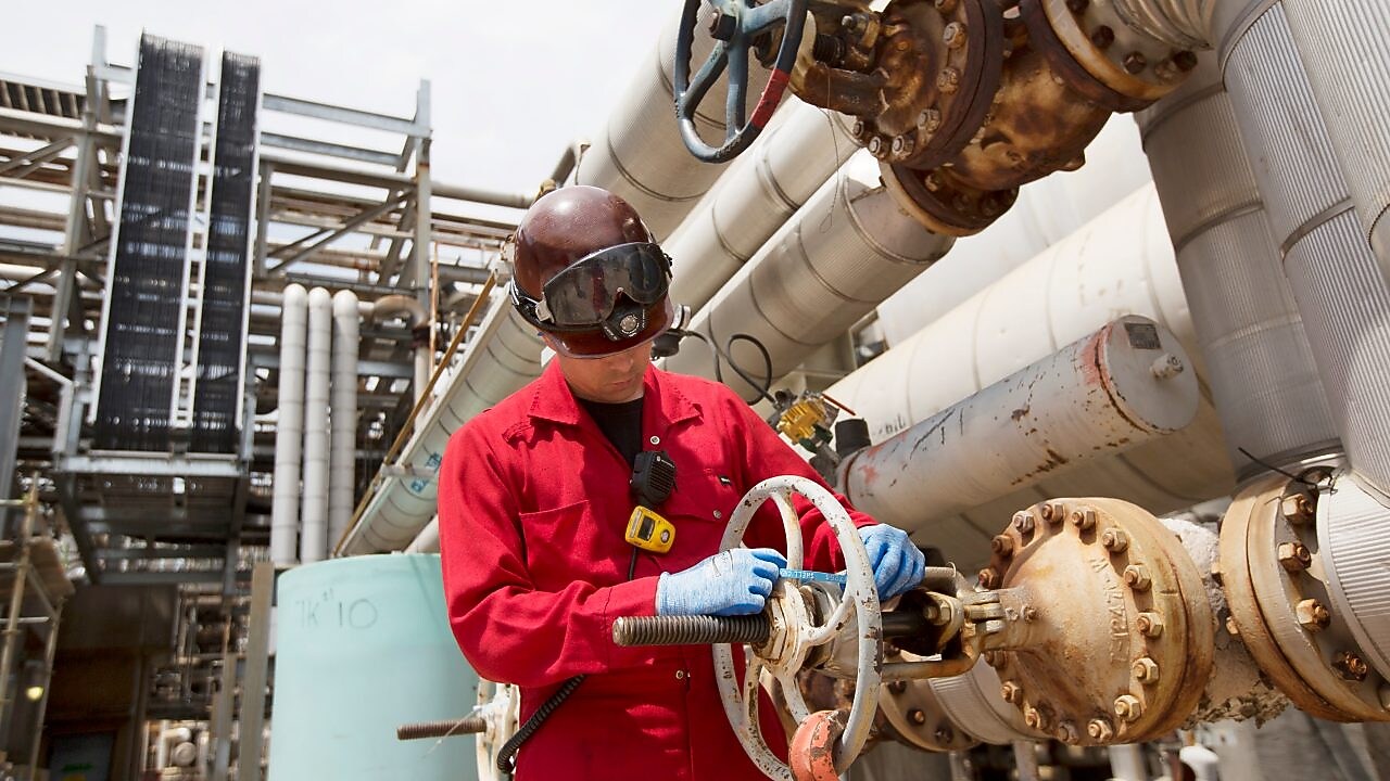 An engineer checks platform equipment for safety