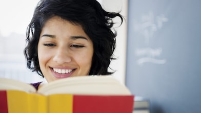 Hispanic woman reading book