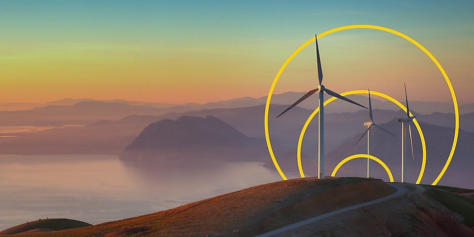 Photo of three wind turbines on a hill with an outline of the Achieving net-zero emissions graph