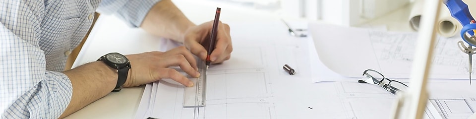 young architect drawing something on paper