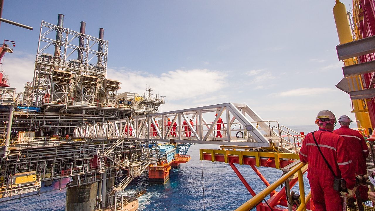 Workers cross over to a new platform built alongside the existing Malampaya deep-water project